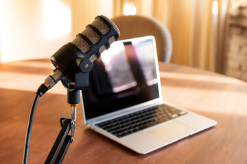 Creating engaging podcast content with a microphone and laptop during an educational interview session