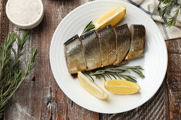 Smoked herring and spices on wooden table, flat lay