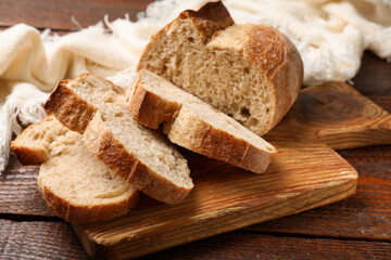 Pieces of fresh bread on wooden table, closeup