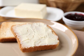 Slices of tasty toasted bread with butter on table, closeup