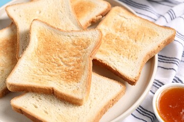 Slices of tasty toasted bread and jam on table, closeup