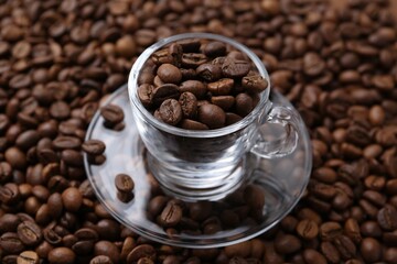 Cup and saucer on coffee beans, closeup