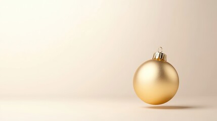 Golden Christmas ornament on a beige background