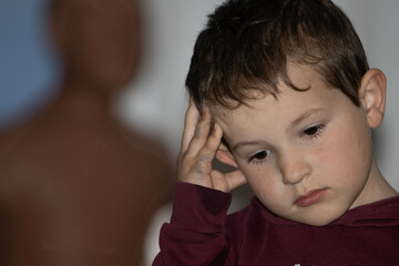 boy thinking and dark shadow behind him 