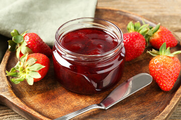 Delicious strawberry sauce and fresh berries on wooden table, closeup