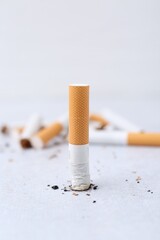 Cigarette butts on light background, selective focus