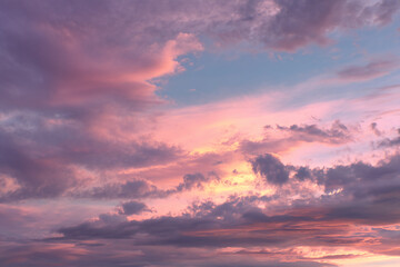 Fototapeta premium Pink and purple sunset sky with layered clouds, creating a serene and peaceful atmosphere, ideal for calm or dreamy concepts