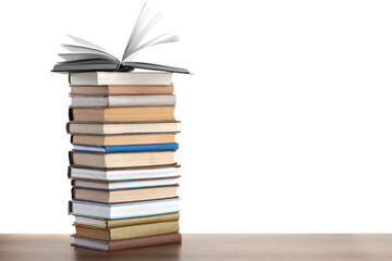 Stack of old books on wooden table against white background
