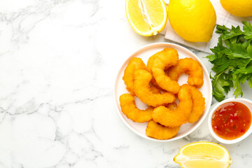 Tasty tempura shrimps served on white marble table, flat lay. Space for text