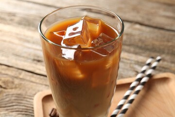 Tasty iced coffee on wooden table, closeup