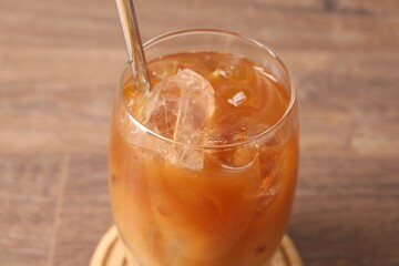 Tasty iced coffee on wooden table, closeup