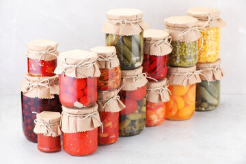 Many jars with different pickled products on light table