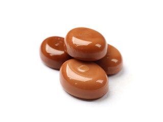 Tasty sweet caramel candies isolated on white
