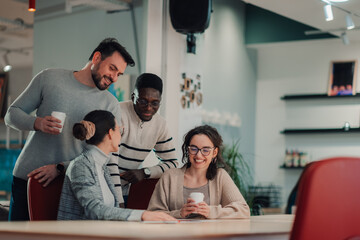 Smiling businesspeople having informal meeting in modern office