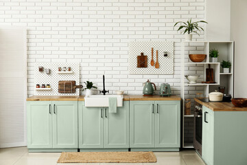 Stylish light kitchen with pegboards and kitchenware