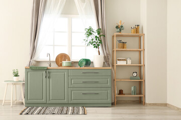 Interior of stylish kitchen with white counters, window, sink and shelving unit