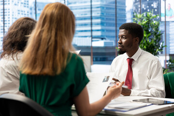 Obraz premium Team of headhunters tasked with hiring best talent to fill open company position, interviewing person. HR coworkers hired to assess skills and qualifications of candidate, doing meeting in office