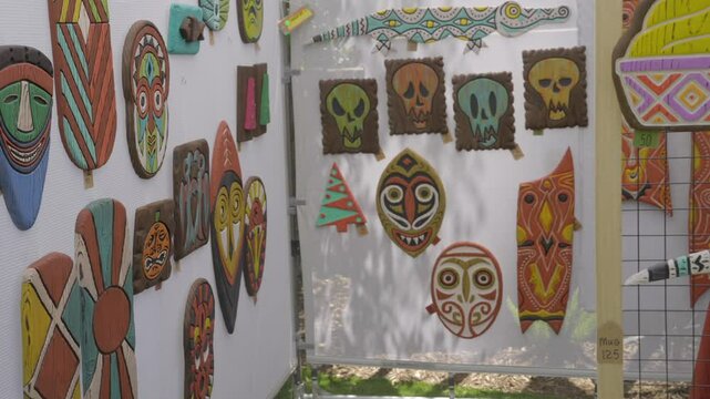 This video shows a white vendor&rsquo;s wall fully covered with colorful, retro tiki-themed art. The vibrant designs and nostalgic style evoke a playful, island-inspired aesthetic&mdash;perfect for content relate