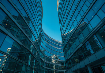 Modern Glass Skyscrapers Against Clear Blue Sky - Architectural Photography, Cityscape, Urban Scene, Office Buildings.