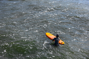 Male surfer on a surfboard. Surfer on a surfboard on a sea wave. Ocean. Surfing.