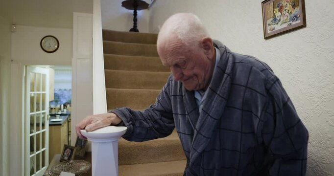 House, steps or old man in retirement walking with difficulty, problems or struggling from medical surgery. Life insurance, senior or elderly person in injury recovery climbing down staircase at home