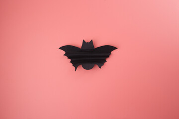 Simple bat cutout on pink surface viewed from above, step in Halloween paper craft for kids, useful...