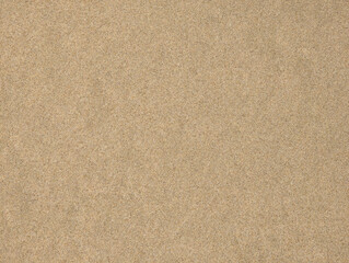 Top view and close-up texture of fine smooth dry Mediterranean beige beach sand with grainy textures, natural patterns across sandy surface, Valencia, Spain. Summer background wallpaper.