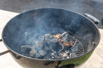 A black grill with a lot of smoke coming out of it