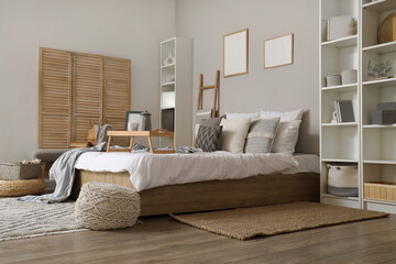Interior of stylish bedroom with ladder and shelf units