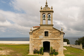 Fototapeta premium A small church with a bell tower and a sign on the front