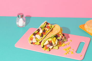 Mexican tacos with chicken, rice, beans, and fresh vegetables