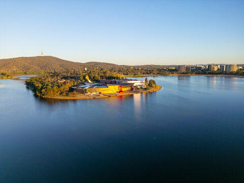 Drone view of Canberra showcasing Lake Burley Griffin at sunset