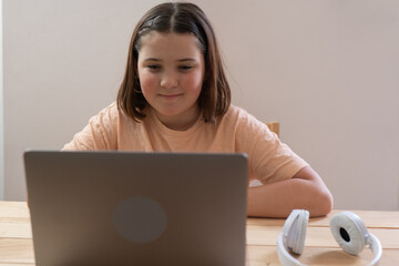 Young Student Engaged in Online Learning with Laptop
