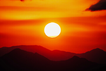 Hot morning sun rising above the San Gabriel Mountains in Los Angeles California.