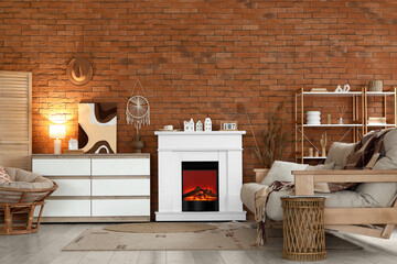 Interior of stylish modern living room with fireplace, armchair and sofa near brick wall