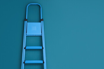 Metal stepladder near blue wall