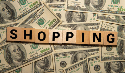 Wooden letter tiles spell out the word 'SHOP' on a light blue background