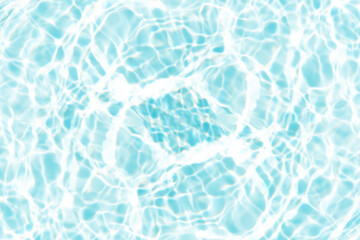 Blue water with ripples on the surface. Defocus blurred transparent blue colored clear calm water surface texture with splashes and bubbles. Water waves with shining pattern texture background.