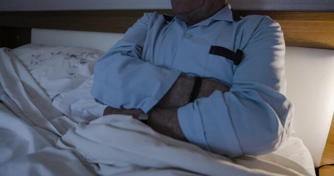 Senior man, bed and stomach pain with cramps, ibs or gastritis while suffering from injury. Retired male, ill or sick in his bedroom with abdominal ache and hurt due to appendicitis and bad health