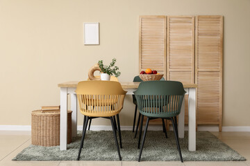 Interior of dining room with table and wooden folding screen