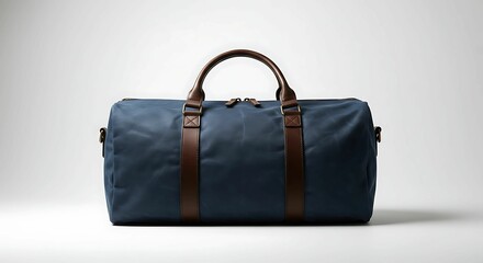 Stylish navy blue duffel bag with brown leather accents sits centered against a clean, bright white backdrop showing its sleek design aesthetic.