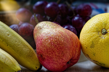 Fresh pear, bananas, grapefruit and grapes creating a colorful still life