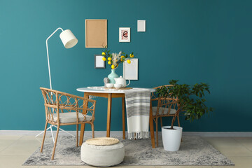 Interior of room with dining table, lamp and pouf