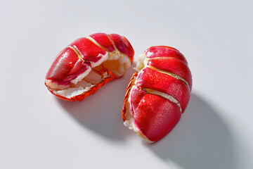 Bright red lobster tails arranged elegantly on a clean white background. Perfect for upscale dining and seafood restaurants. Concept of gourmet cooking, culinary arts, seafood industry