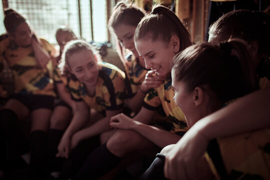 Girls soccer team getting ready in locker room before game