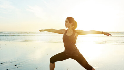 Person, earphones or beach yoga at sunset for balance, calm or zen mindset in peace mockup space. Warrior pose, music or wellness frequency for awareness, stretching or relax body movement by ocean
