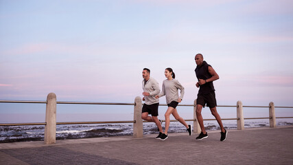 Fitness, men and woman on promenade for exercise, wellness and endurance training. Athlete, friends and running challenge with workout, physical health and resilience for summer and cardio together