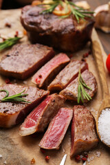 Pieces of delicious beef meat with spices on table, closeup