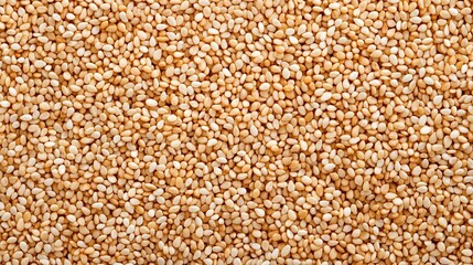 Fototapeta premium under 200 characters): A close-up view of many raw sesame seeds, showcasing their light brown and beige tones in a densely packed pattern.