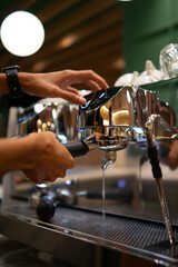 Barista operating an espresso machine